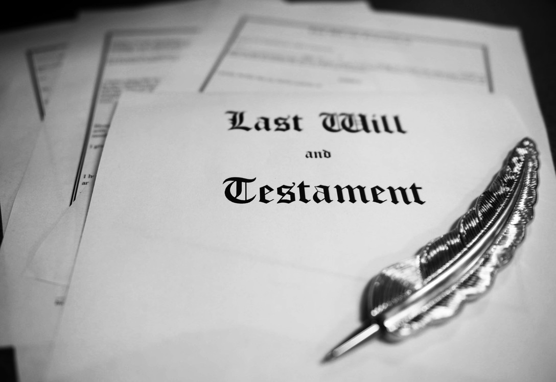 Metal pen on top of last will and testament